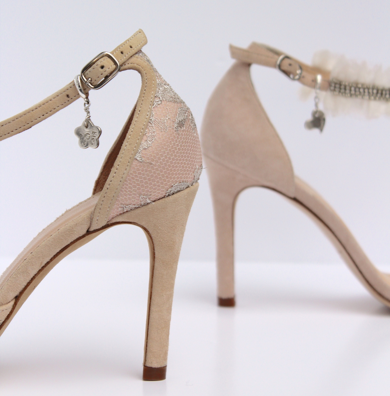 silver shoe charms on blush suede shoes