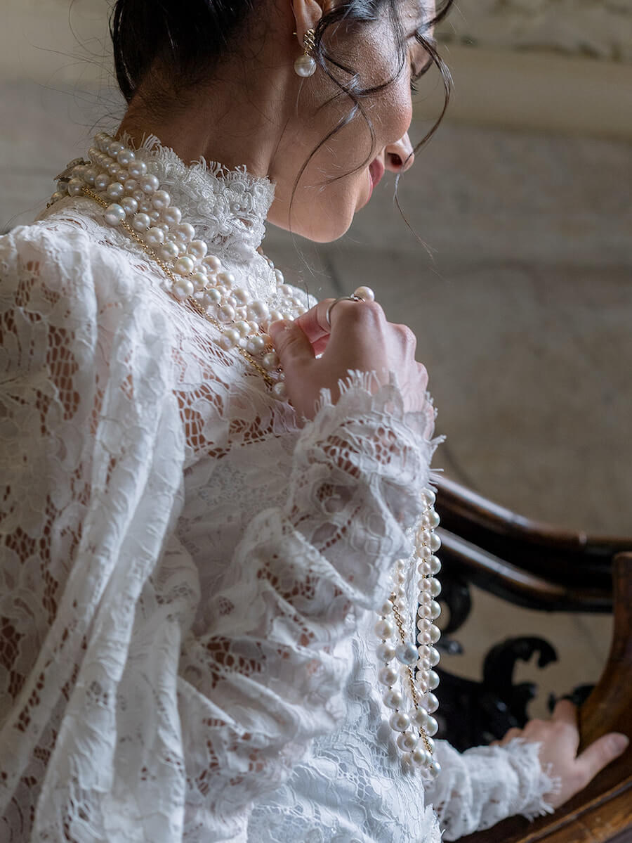 bride wearing lace and pearls 