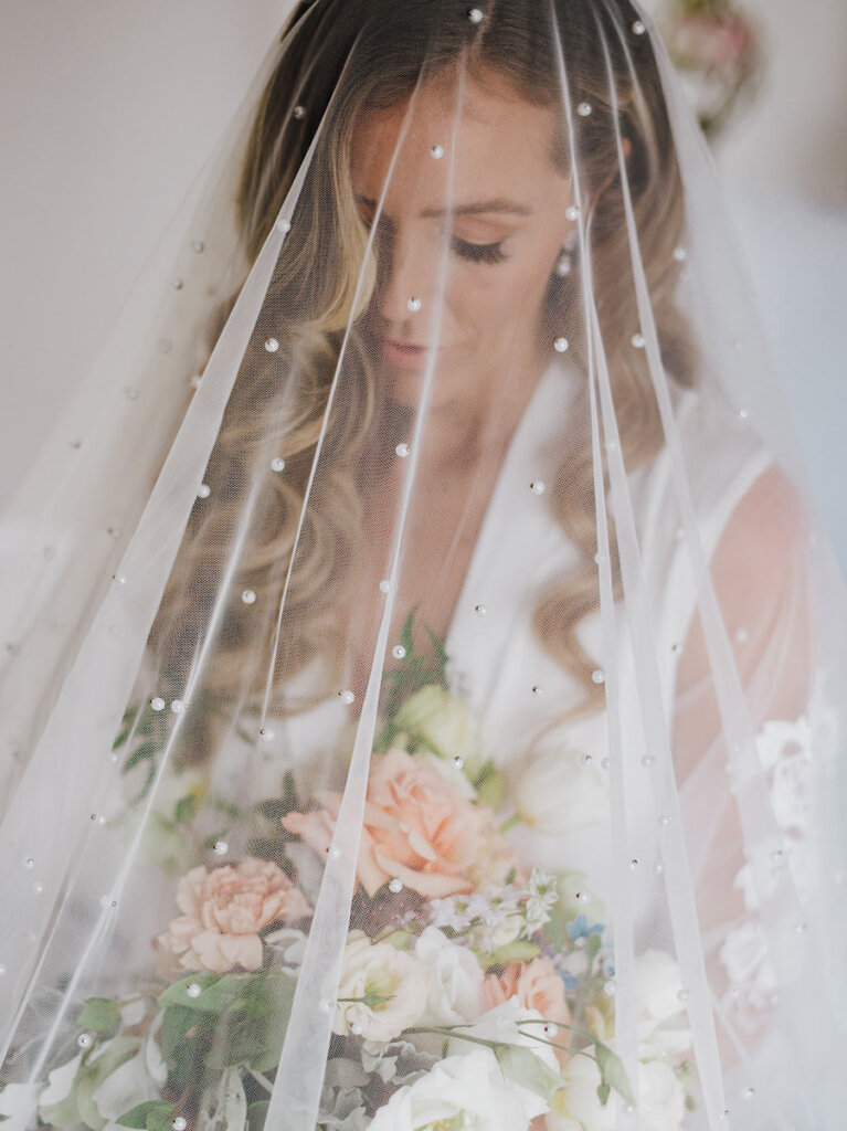 Bride with pearl veil and bouquet