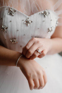 Bride wearing wedding dress + jewellery
