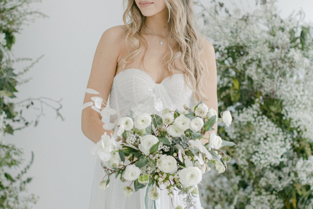 Bride with white+ green wedding flowers
